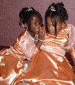 Flower girls dresses in a peach satin designed by Cathy